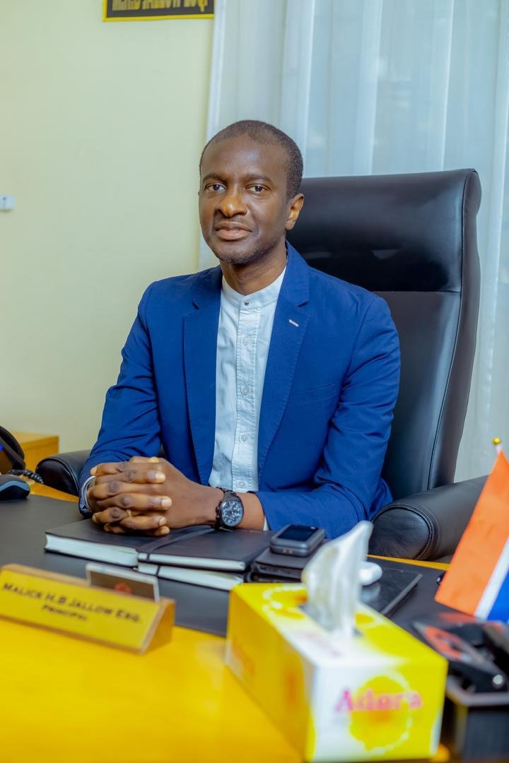 Malick H.B Jallow seated in his office